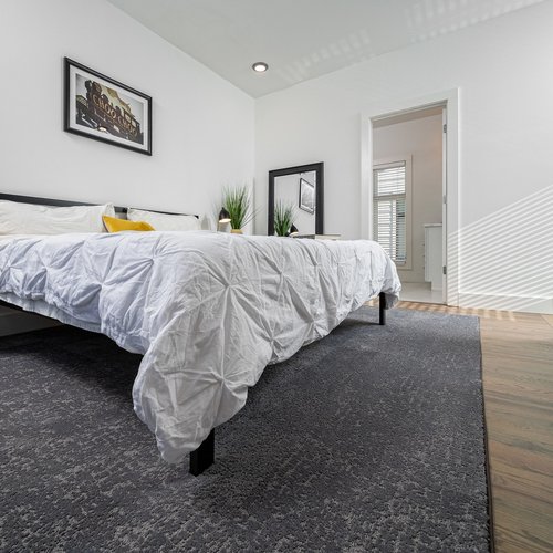 bedroom with grey area rug