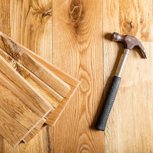 hammer and planks on hardwood