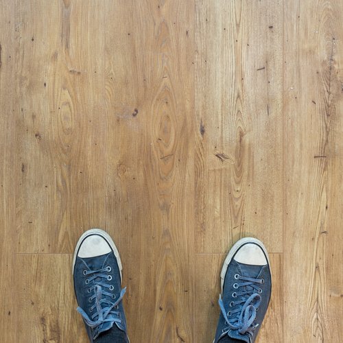 person standing on hardwood floor