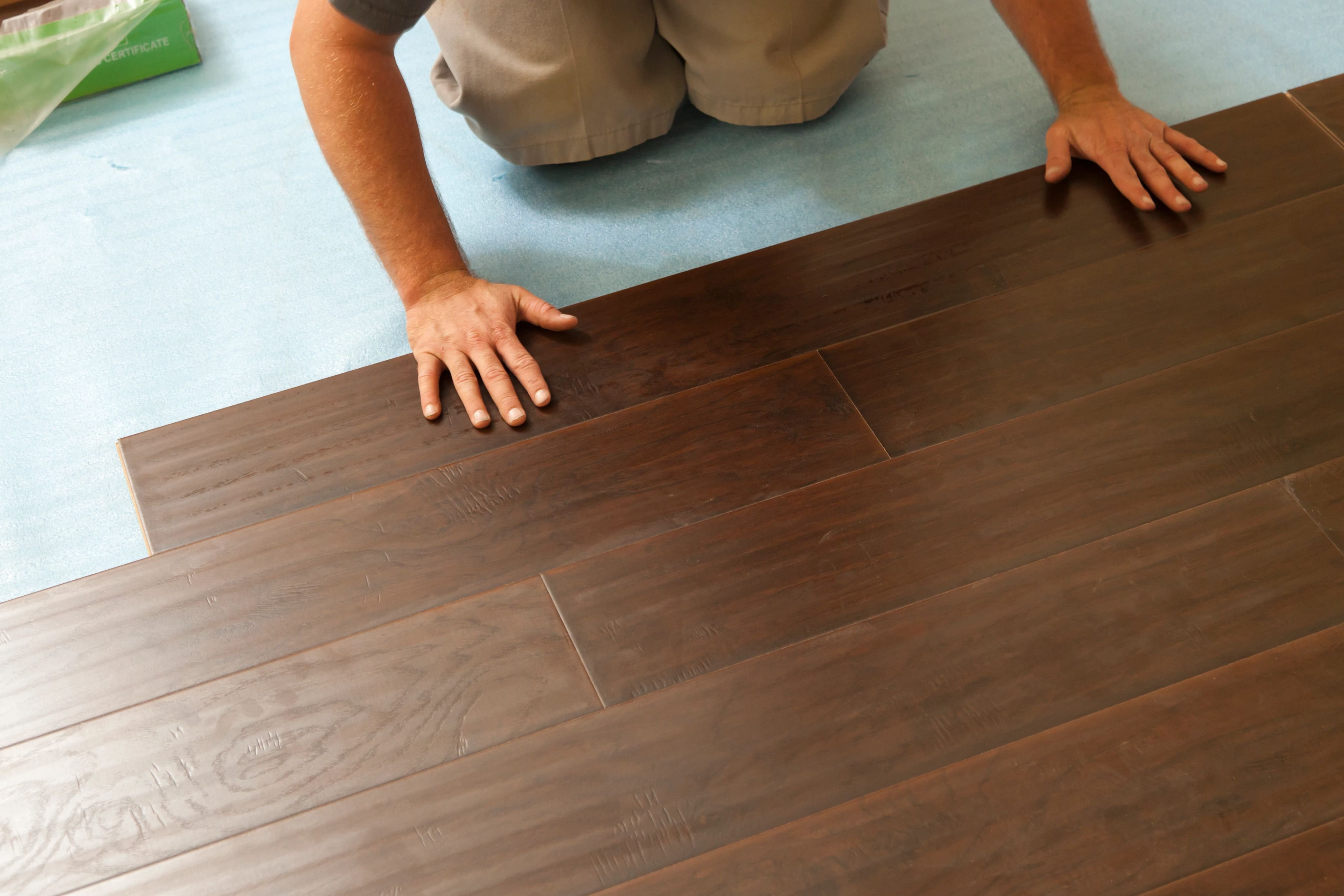 person installing hardwood floor