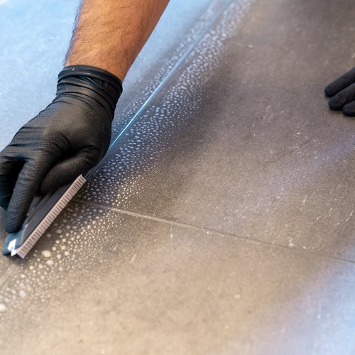 person installing tile floor