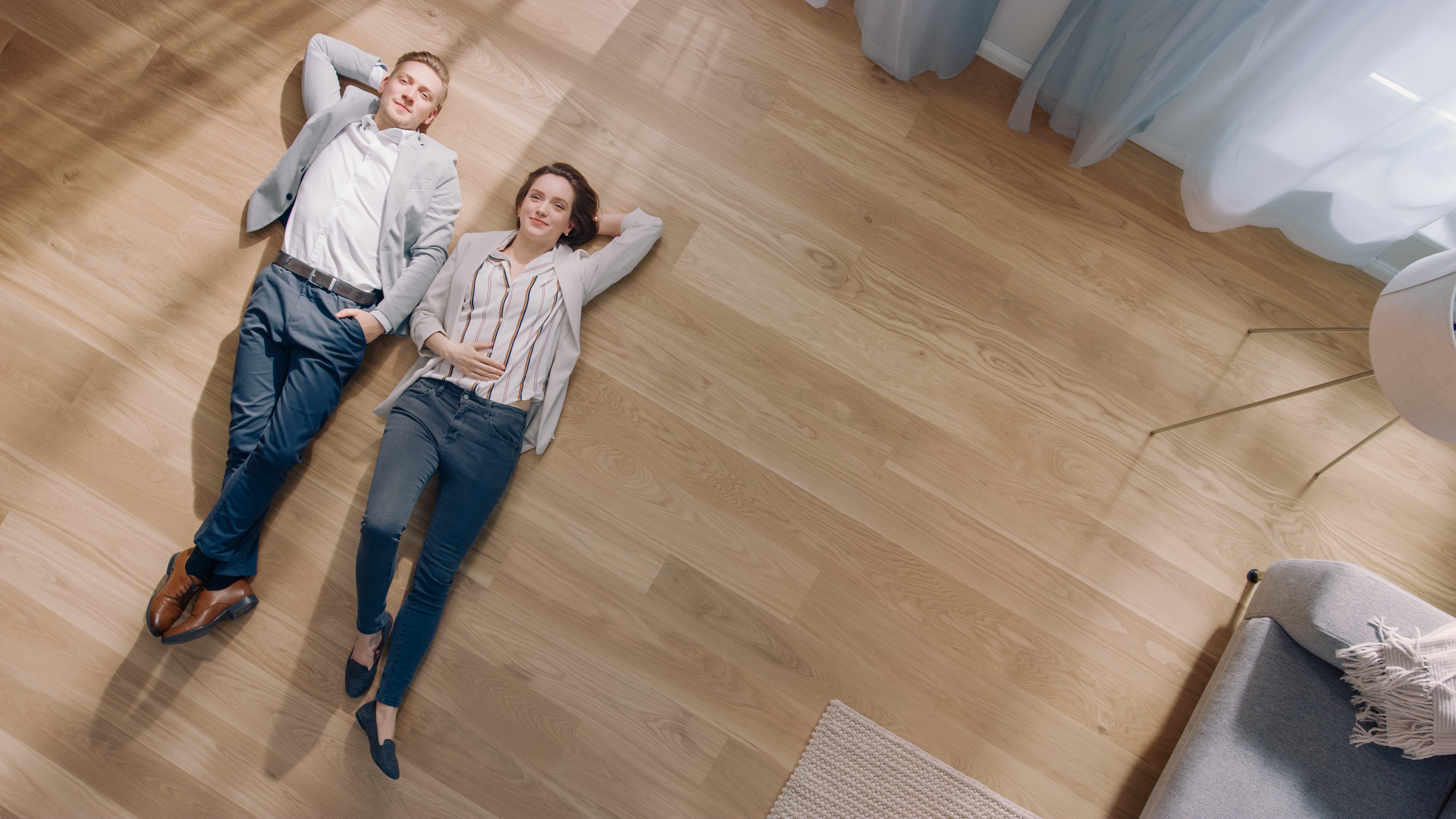 couple laying on the floor of their home