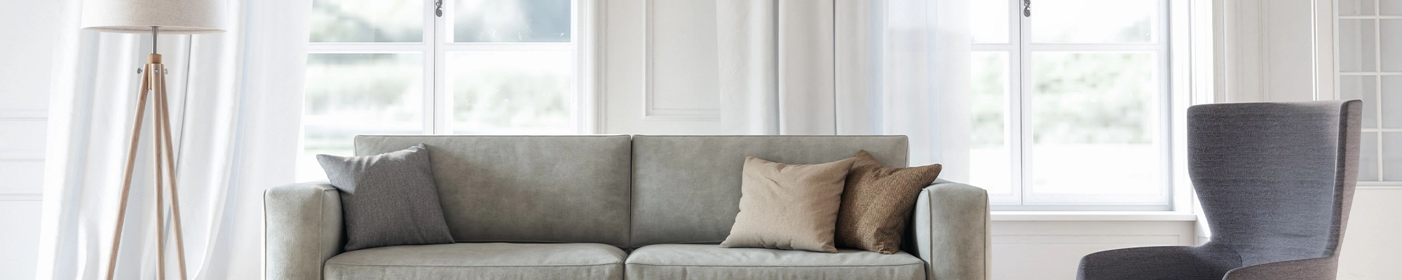 grey couch, seat and lamp in front of window