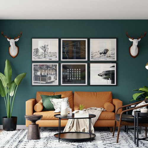 brown leather couch in room with green wall